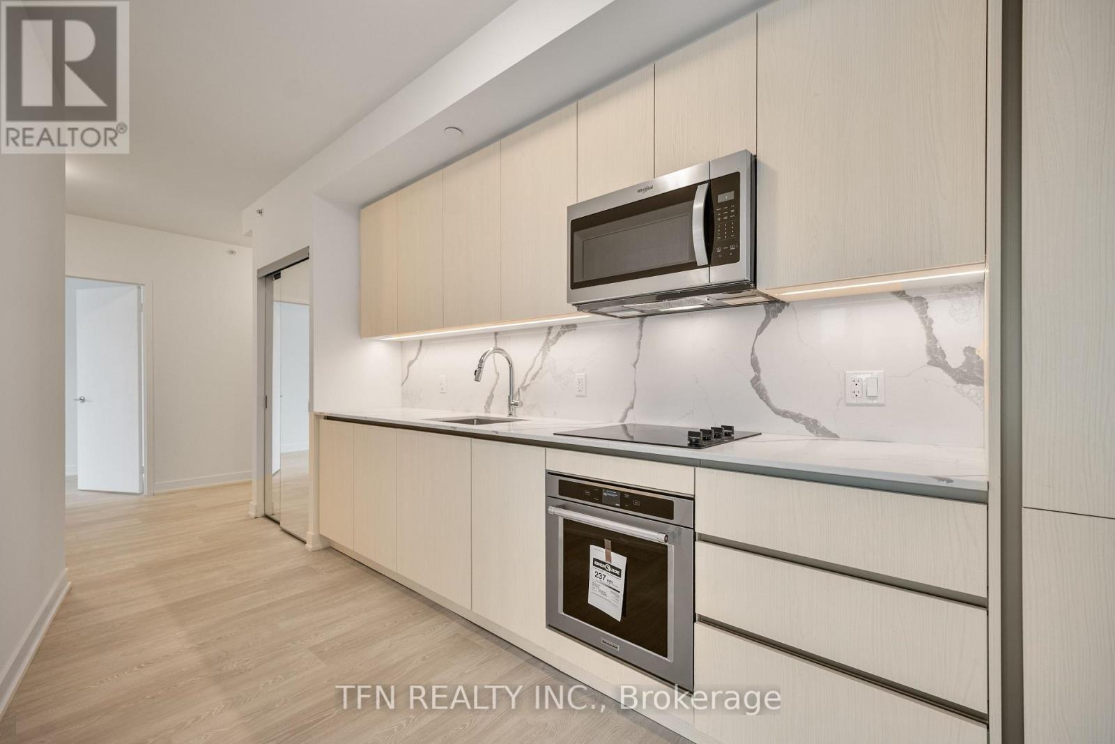 A modern kitchen with a microwave above the stove.