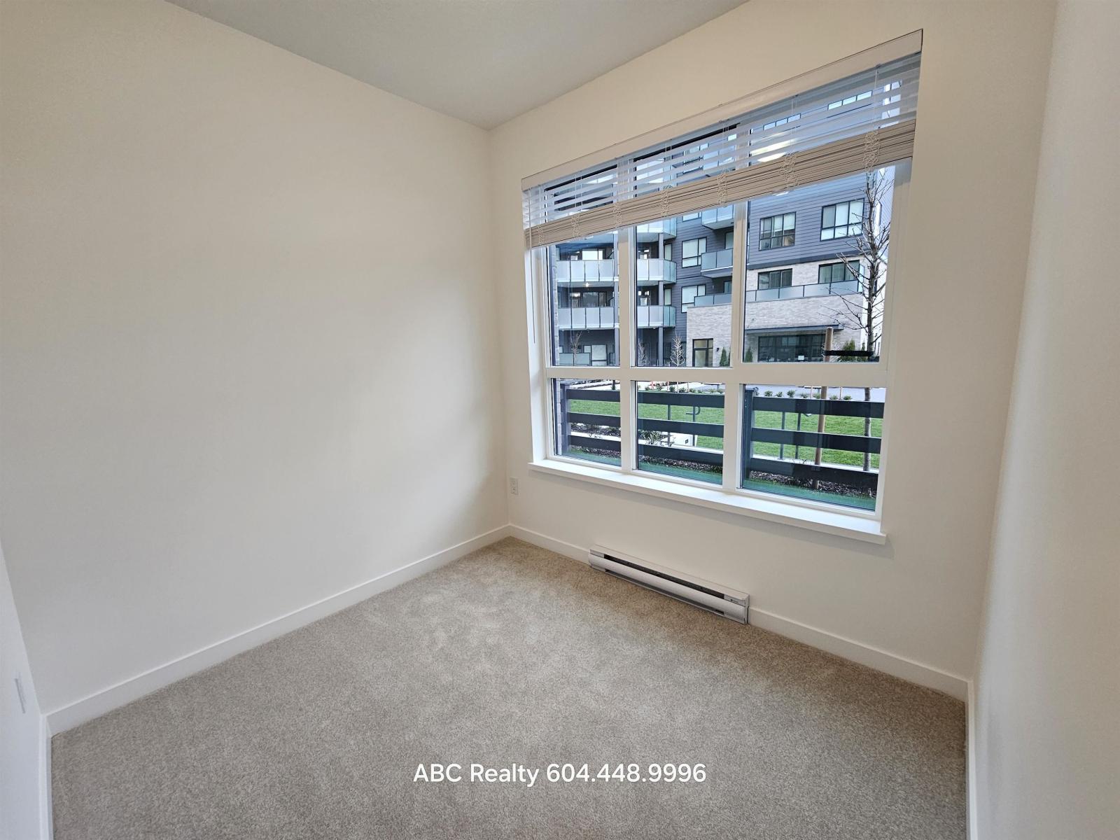 A room with a large window overlooking a building.