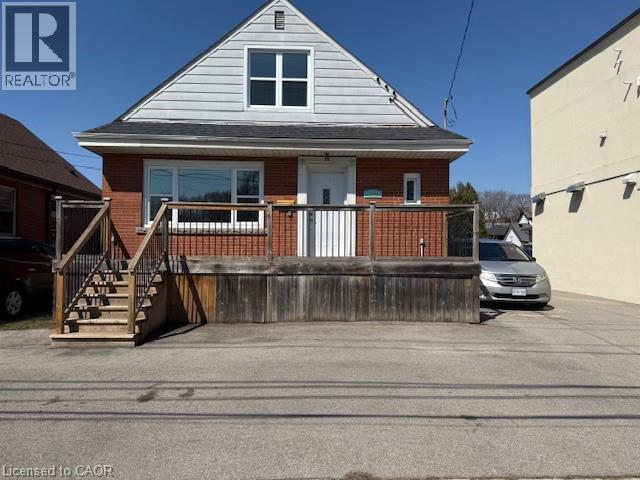 A house with a white door and a porch with a railing.