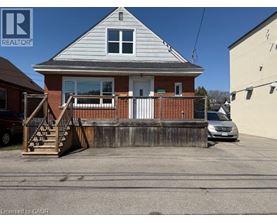 A house with a white door and a porch with a railing.