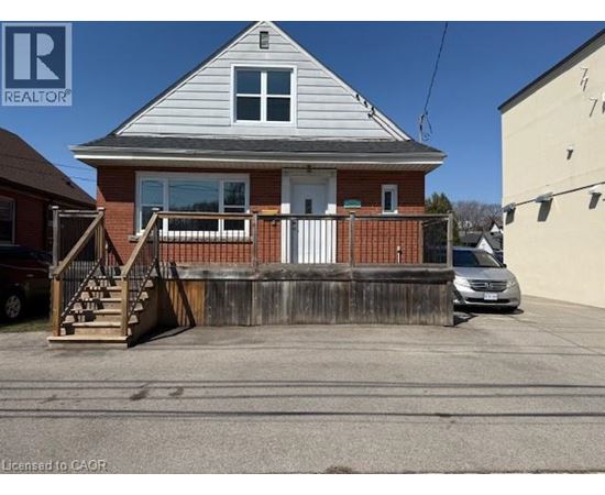 A house with a white door and a porch with a railing.