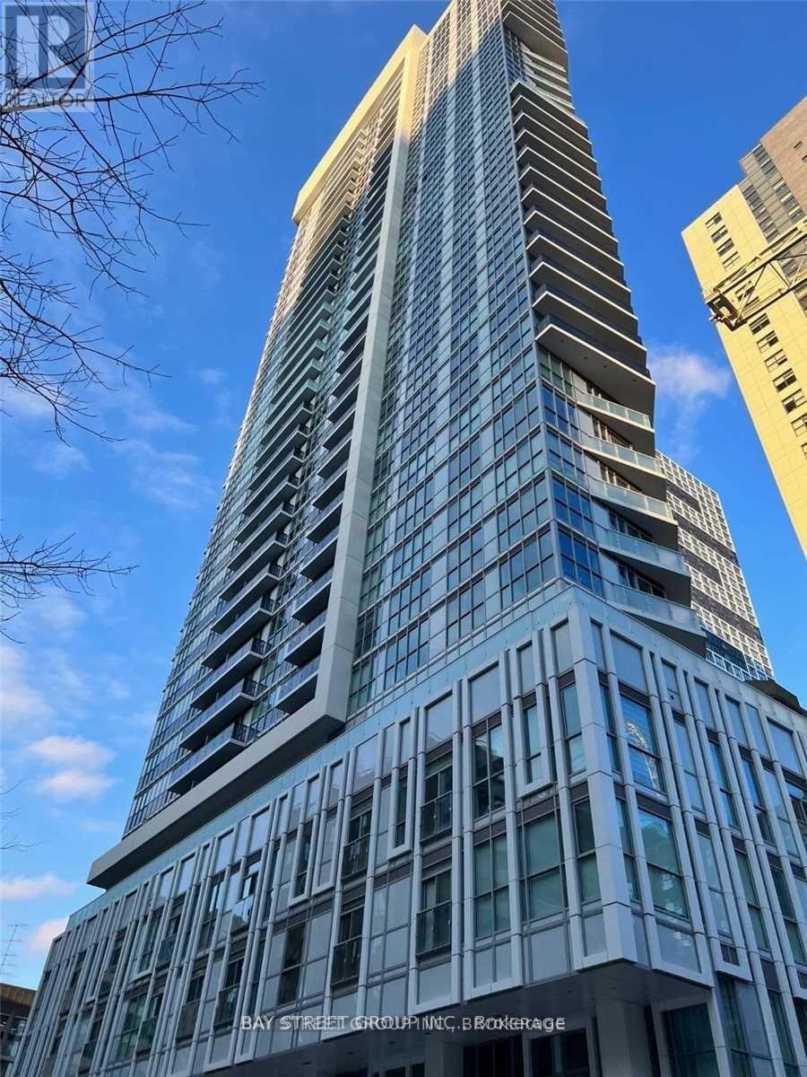 A tall building with a curved top and the words "Bay Street Group" on its facade.