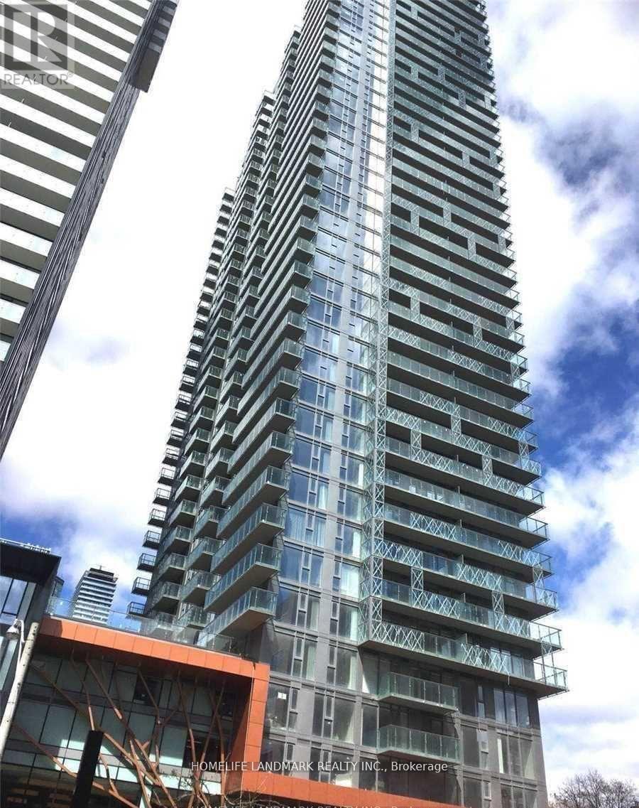 A tall building with a glass facade and a sign that reads "Homelife Landmark Realty Inc. Brokerage".