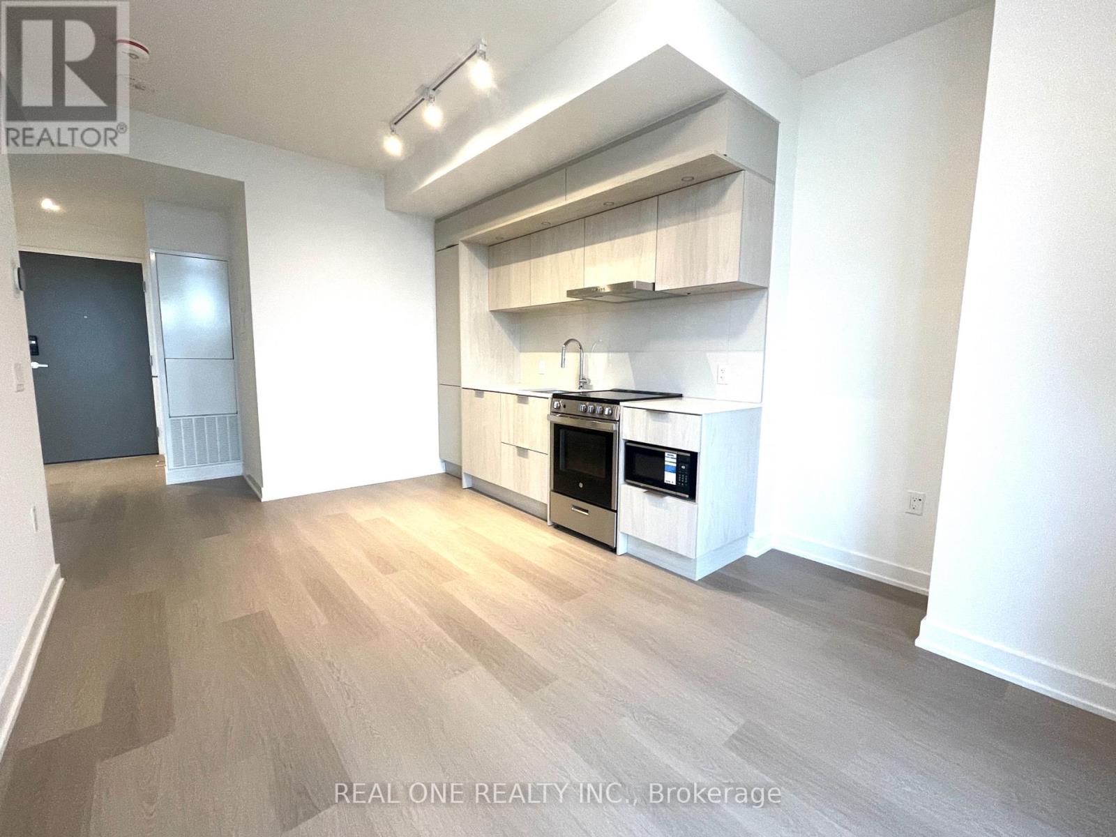 A modern kitchen with a stainless steel oven and microwave.