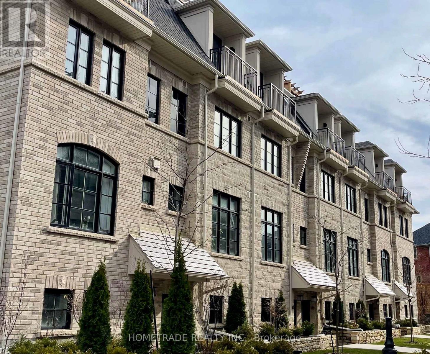 A large, multi-story building with a stone facade and multiple balconies.