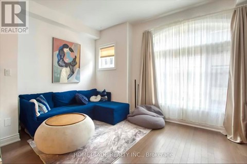 A living room with a blue couch and a large bean bag chair.