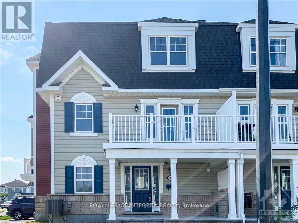 A two-story house with a balcony and a sign that says "Royale Integrated Realty Brokerage.".