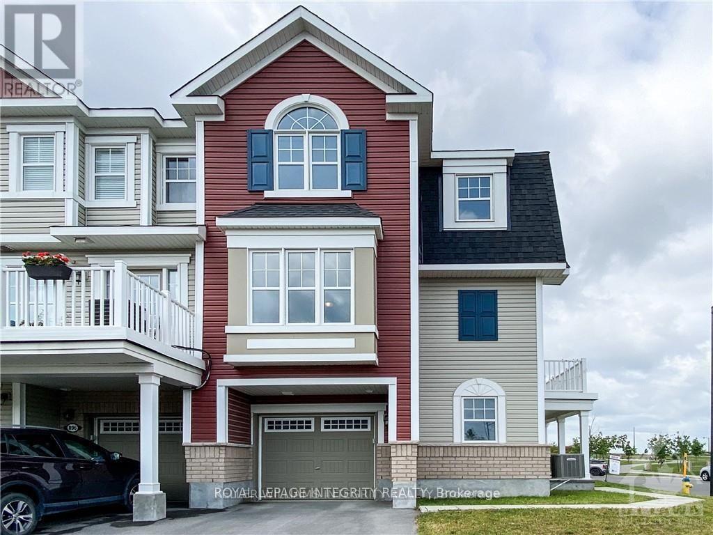 A two-story house with a red and beige exterior and a black car parked in front.
