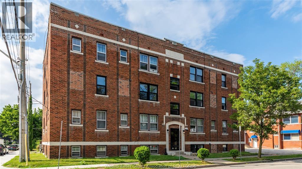 A red brick building with a white trim around the windows and doors.