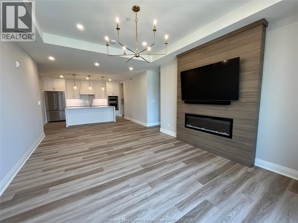 A living room with a television and a fireplace.