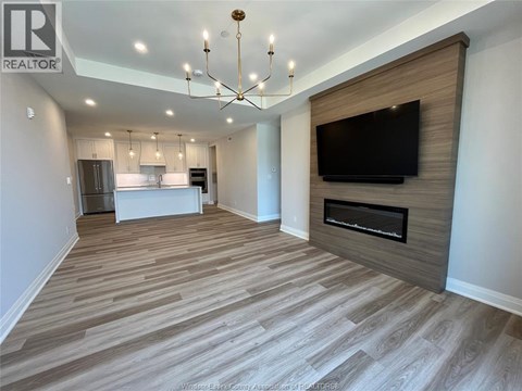 A living room with a television and a fireplace.