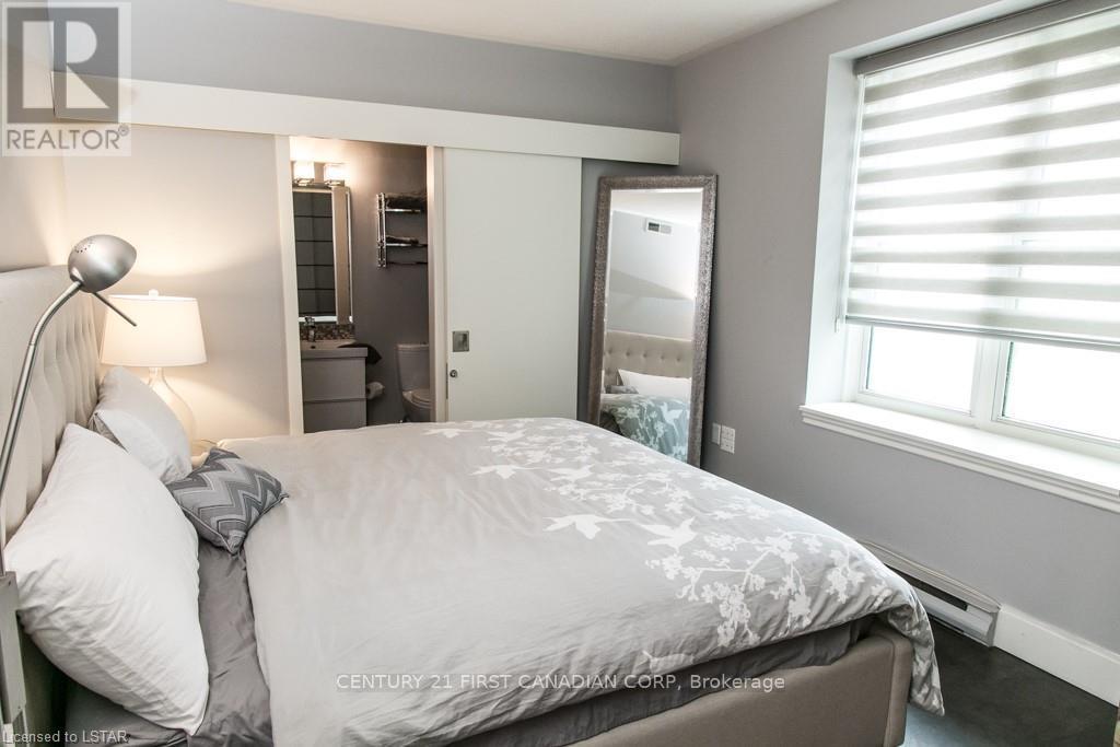 A bedroom with a large bed and a mirror on the wall.