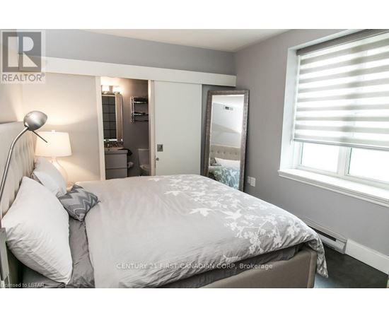 A bedroom with a large bed and a mirror on the wall.