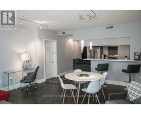 A modern dining room with a glass table and chairs.