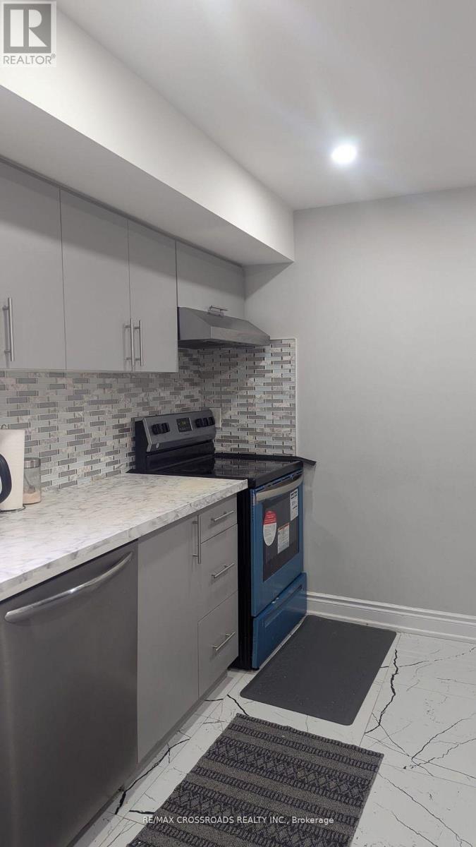 A kitchen with a dishwasher and a microwave.