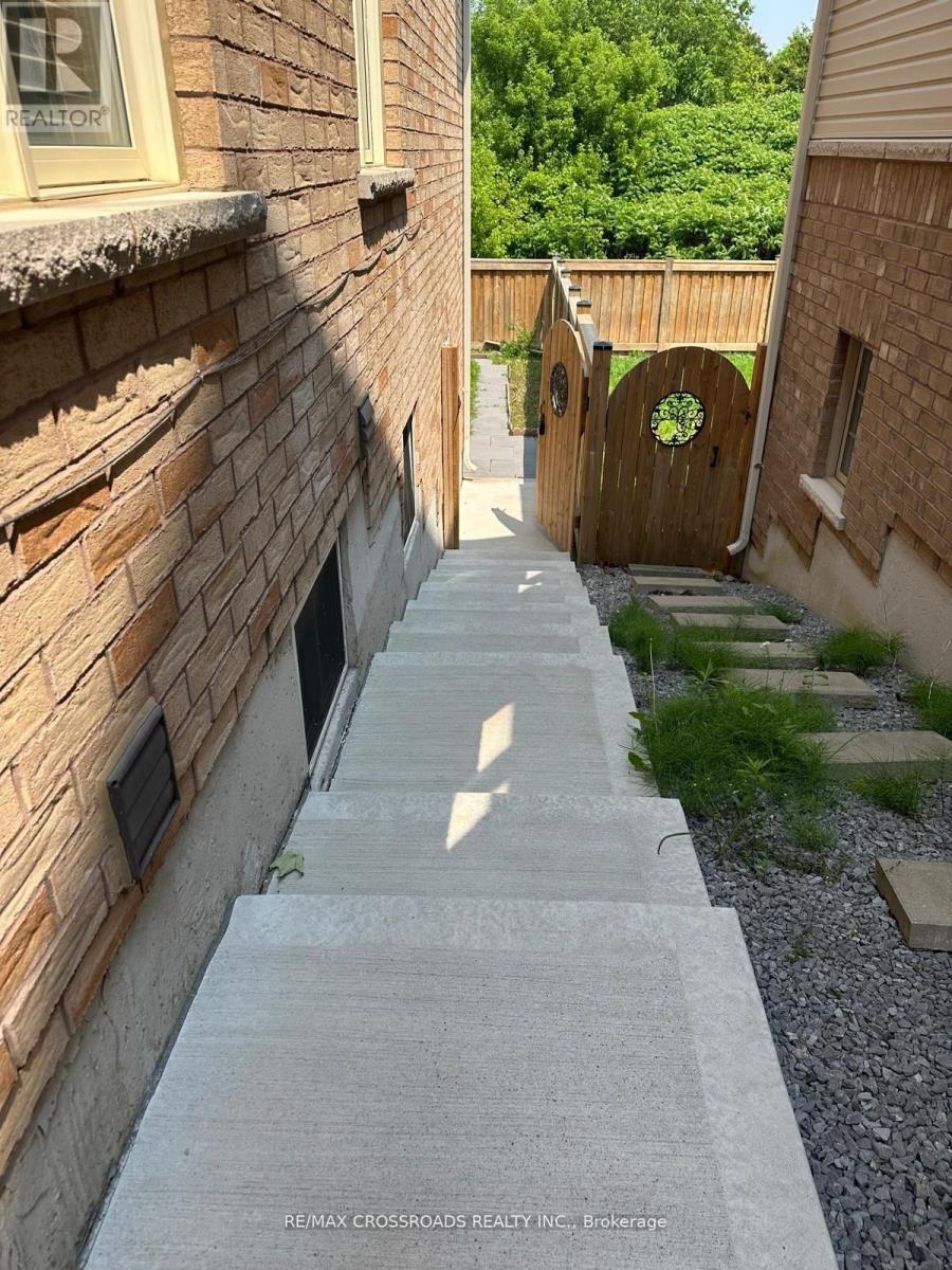 A narrow alley with a stone pathway and brick walls.