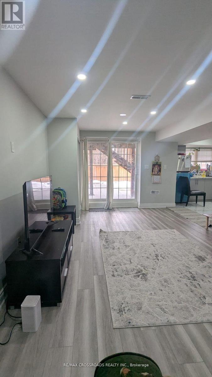 A living room with a television and a rug on the floor.