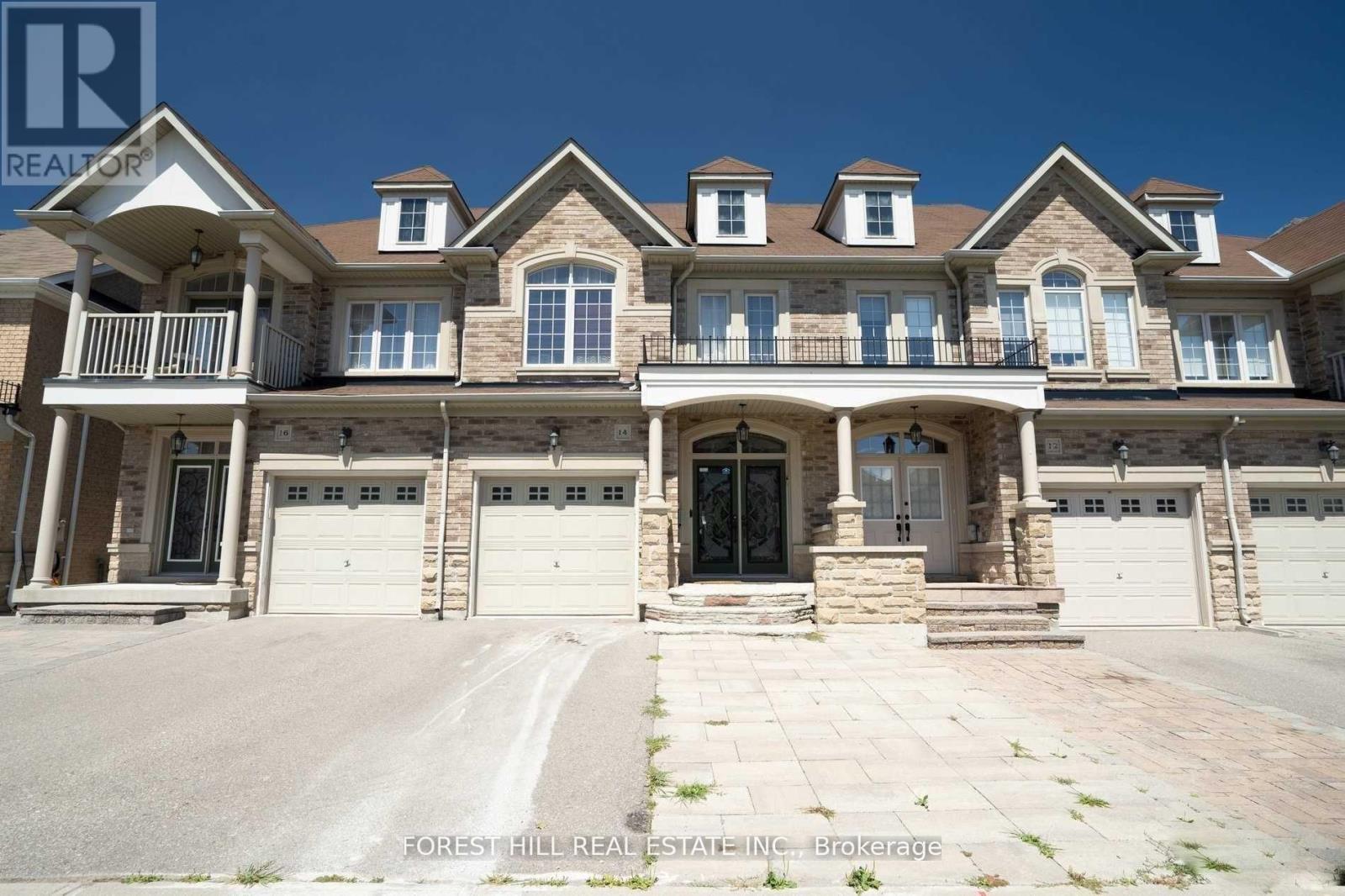 A large, multi-level house with a stone facade and multiple garages.