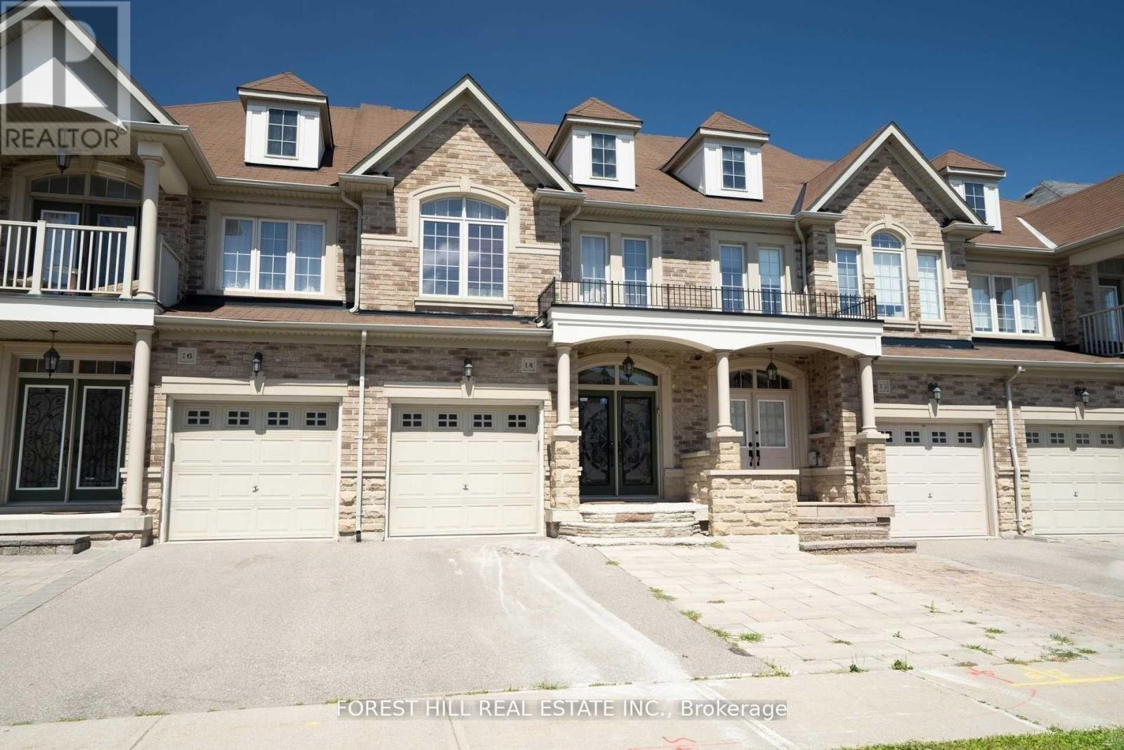 A large, multi-level house with a balcony and multiple garages.