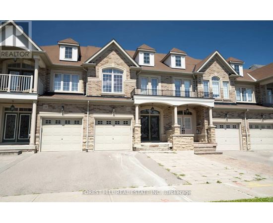 A large, multi-level house with a balcony and multiple garages.