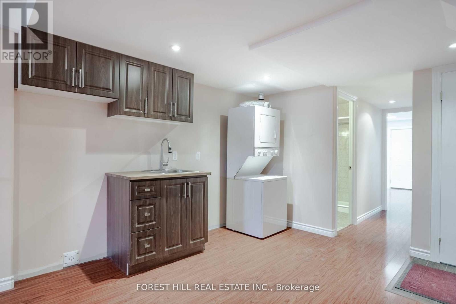 A kitchen area with wooden cabinets and a white refrigerator.