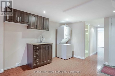 A kitchen area with wooden cabinets and a white refrigerator.