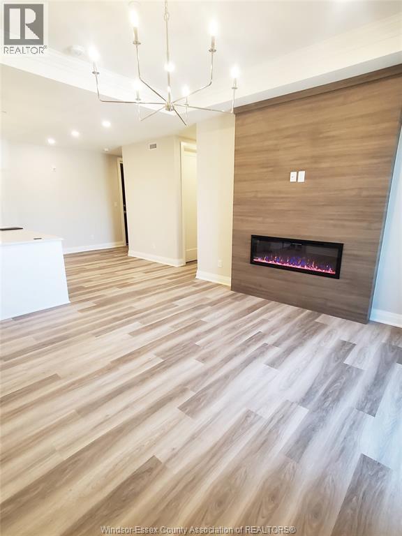 A modern living room with a fireplace and wooden flooring.