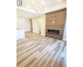 A modern living room with a fireplace and wooden flooring.