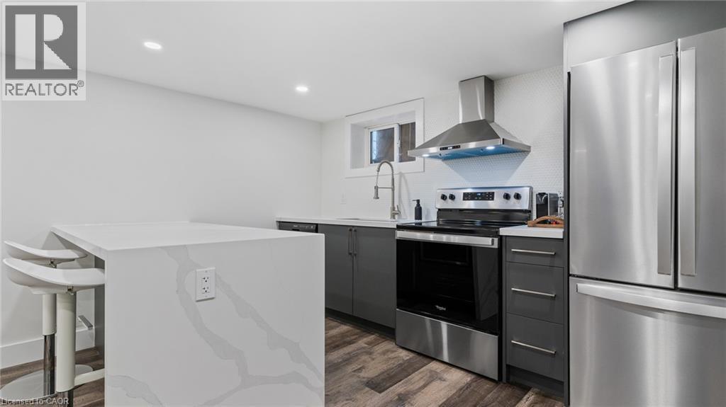 A modern kitchen with stainless steel appliances and a white island.
