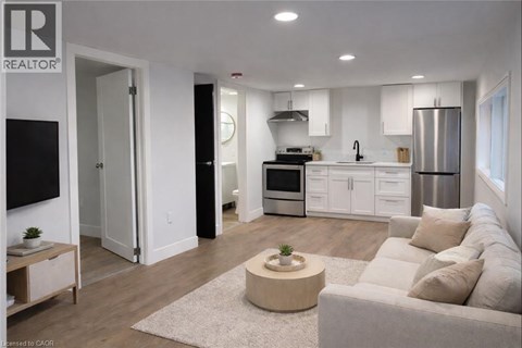 A modern living room with a grey couch and a coffee table.