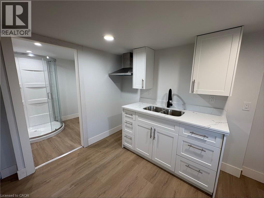 A white kitchen with a sink and cabinets.
