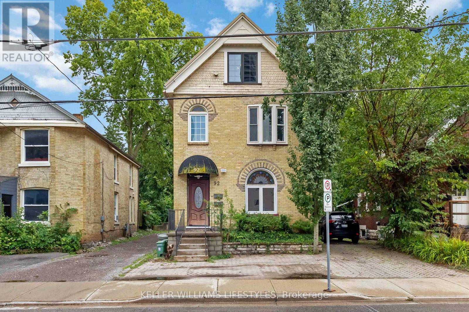 A house with a red door and a sign that says no parking.