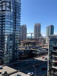 A cityscape with a large building in the foreground and a construction site in the background.