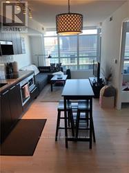A kitchen with a table and chairs in front of a window.