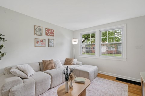 A living room with a grey couch and a coffee table.