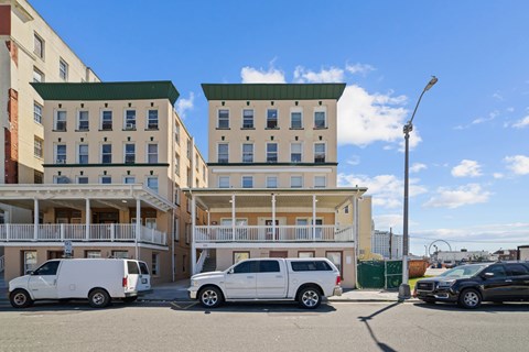 A white van is parked in front of a building.