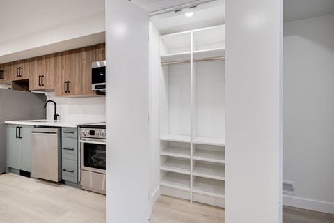 A kitchen with white cabinets and appliances.