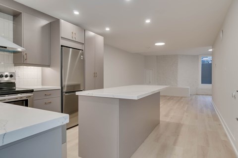 A modern kitchen with a large island in the middle.
