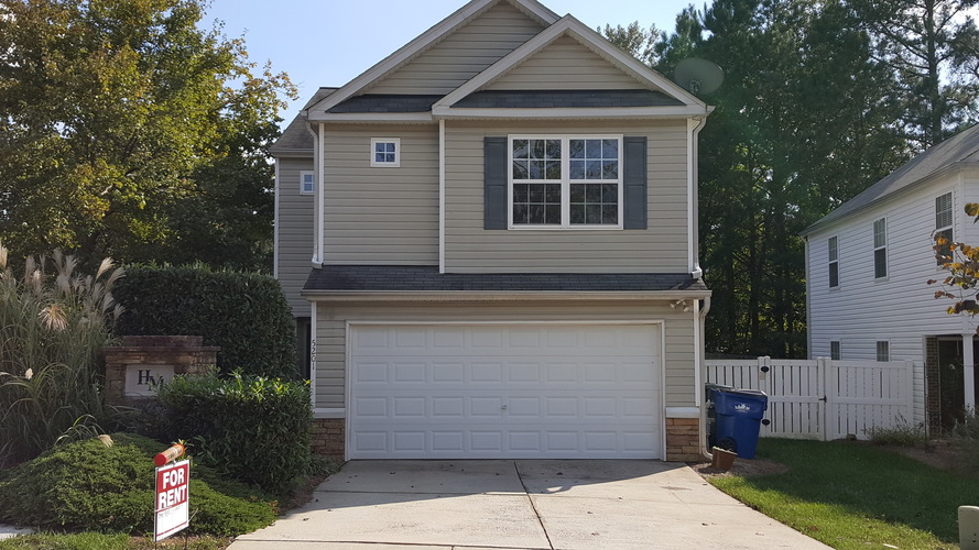 A house with a garage is for sale.
