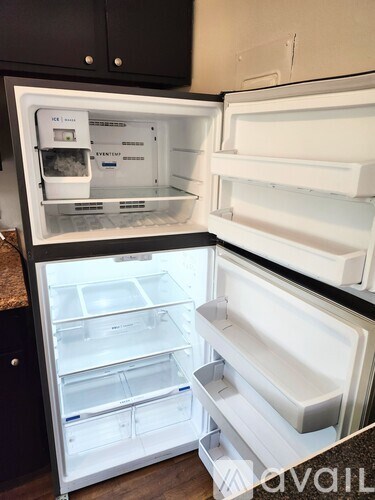 A white refrigerator with the door open and shelves inside.