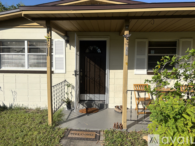 A house with a porch and a mat on the floor.