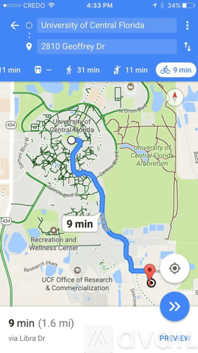 A map on a phone screen shows a route to the University of Central Florida.