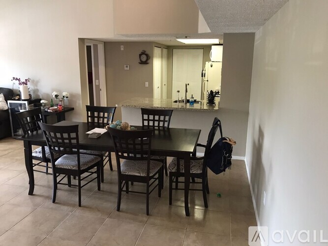 A dining room with a table and chairs.