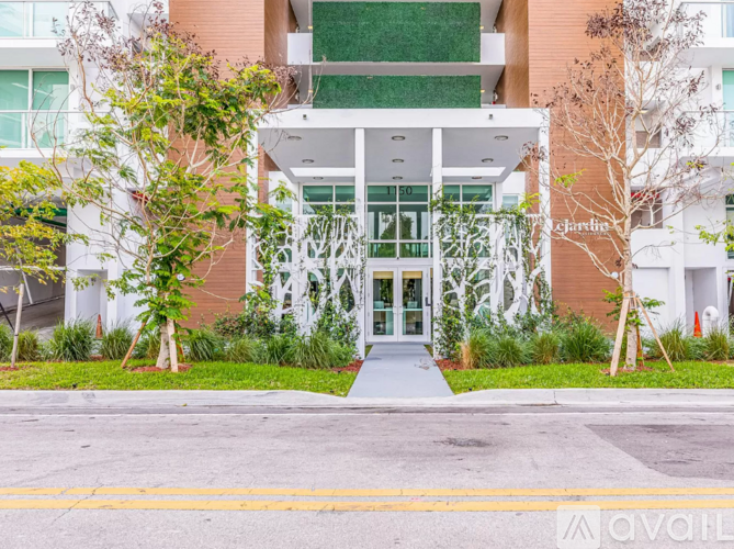A building with a white entrance and a sign that says "Chardonnay".