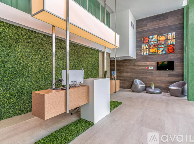 A modern living room with a green wall and a TV.