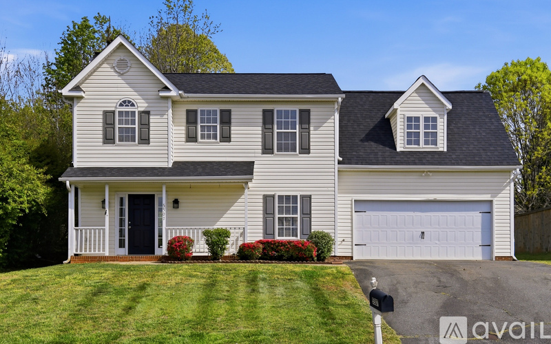 A two-story house with a garage is for sale.