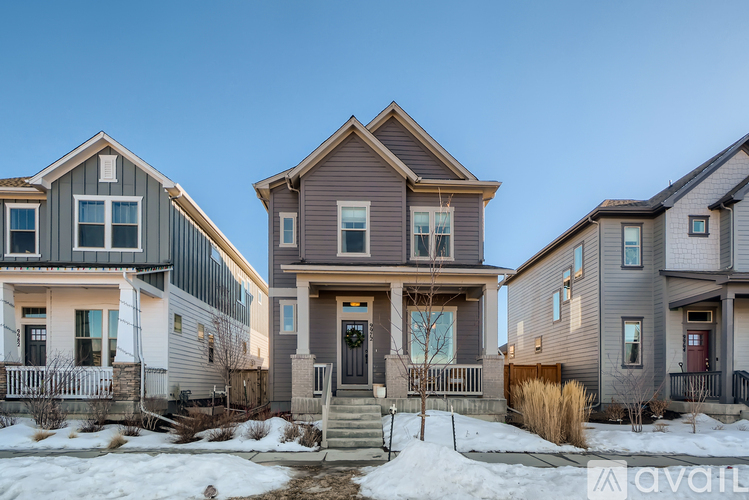 A row of houses with a clear blue sky above them.