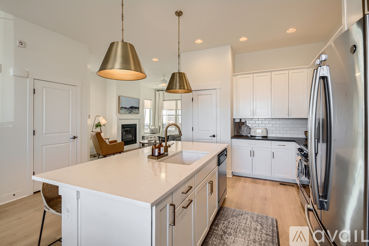 A modern kitchen with white cabinets and a large island.