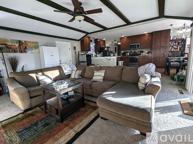 A living room with a brown couch and a coffee table.