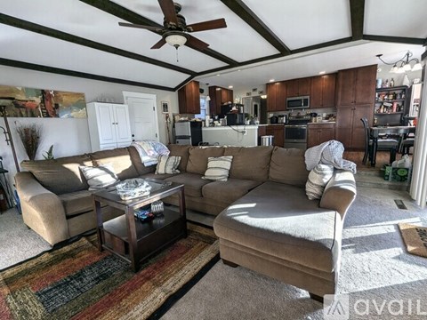 A living room with a brown couch and a coffee table.